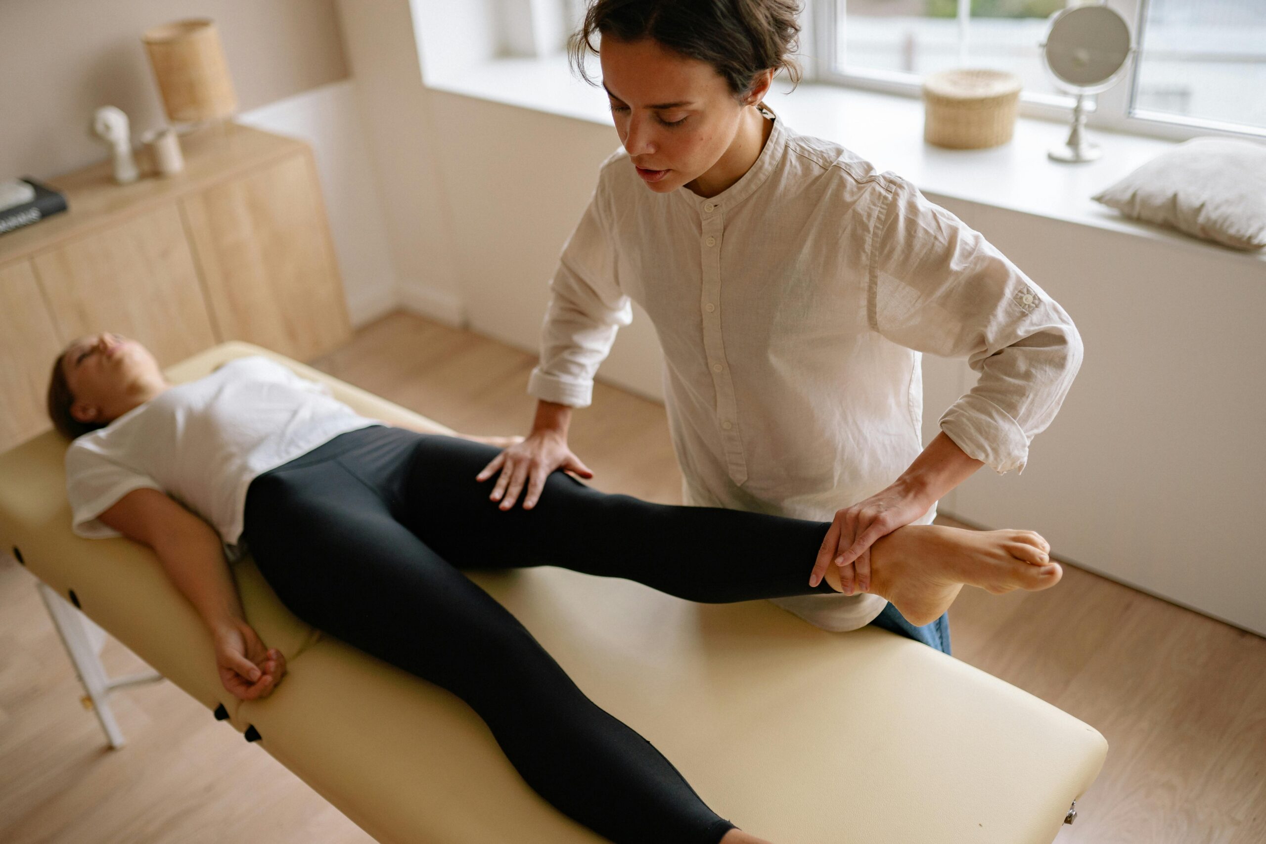 Physiotherapist Holding Womans Leg